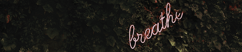 a neon sign that says breathe