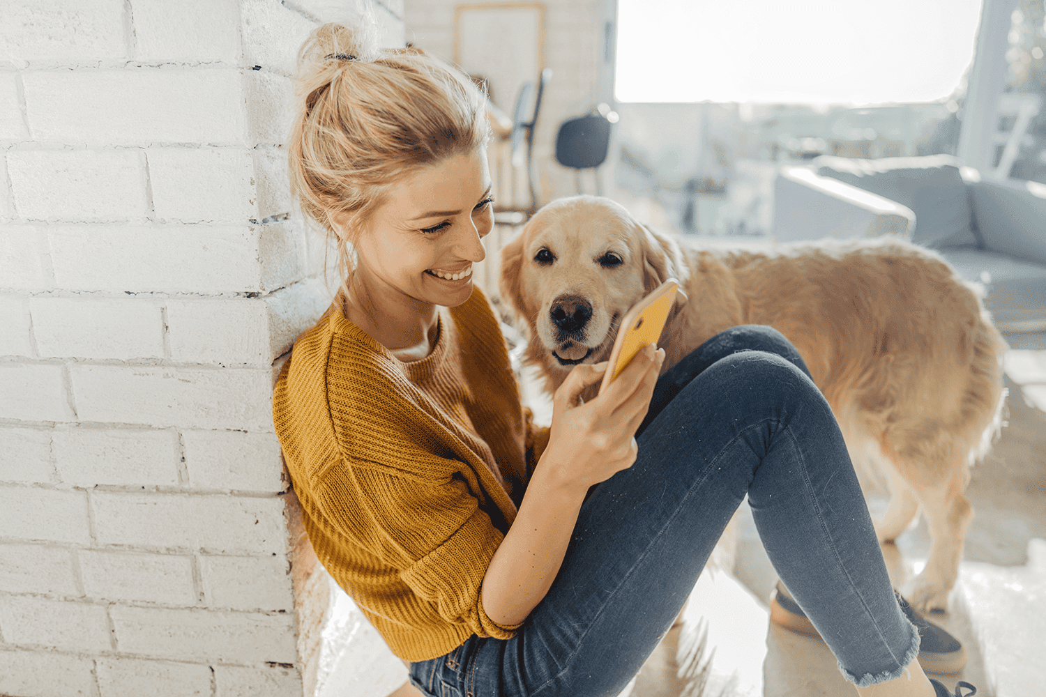 woman on the phone with a golden retriever
