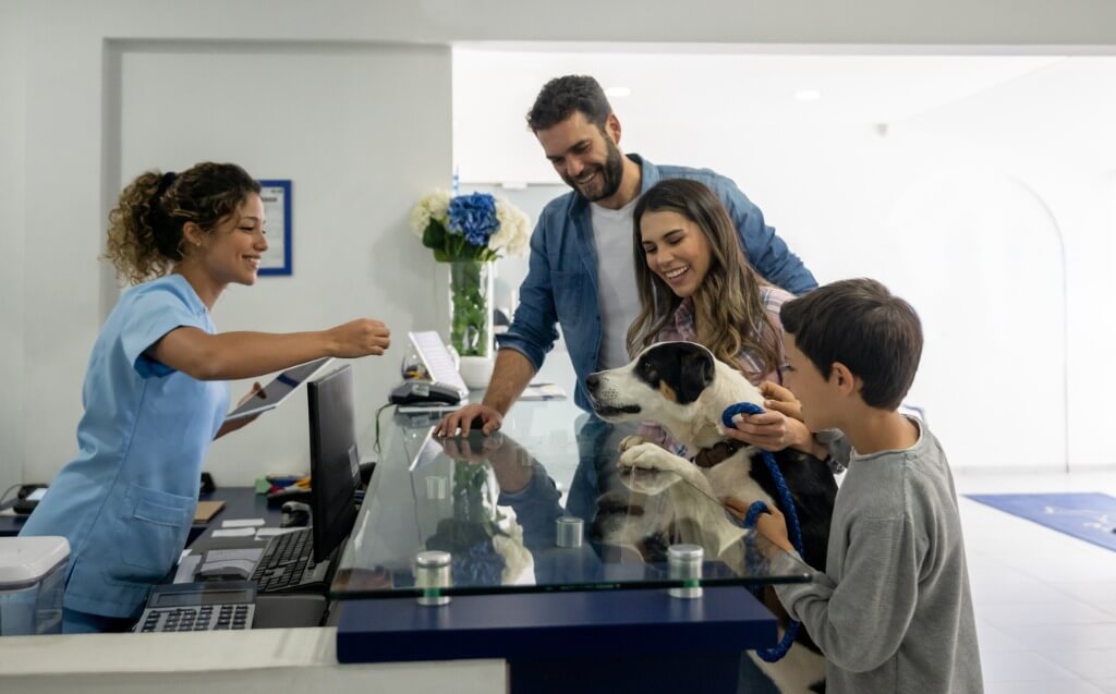 family with their dog at the veterinary reception area